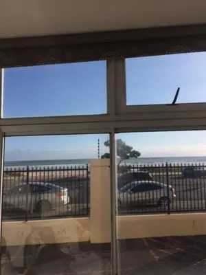 a view of a parking lot through a window at Romilly Beach Apartment in Strand