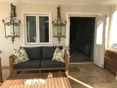 a living room with a couch and a table at Maison Malherbe in Franschhoek