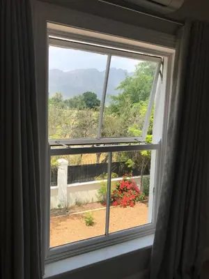 a window with a view of a garden at Maison Malherbe in Franschhoek