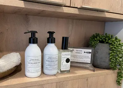 three bottles of moisturizers sitting on a shelf at Abode Africa in Bloubergstrand