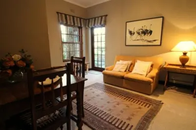 a living room with a couch and a table at The Bergzicht Guest Suite in Cape Town