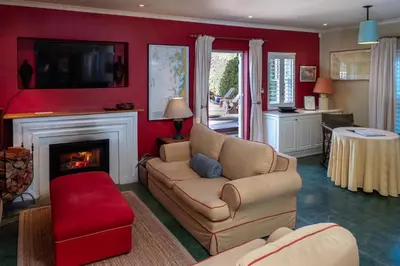 a living room with a couch and a fireplace at Cook's Cottage in Franschhoek