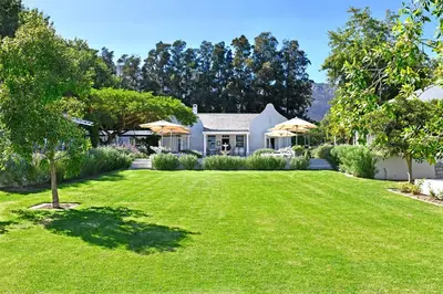 a house with a large yard with green grass at Lavender Farm Boutique Guest House in Franschhoek