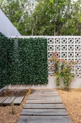 a garden with a fence and a wooden walkway at Lavender Farm Boutique Guest House in Franschhoek