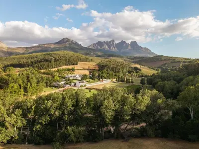 an aerial view of a farm with mountains in the background at AfriCamps at Doolhof Wine Estate in Wellington