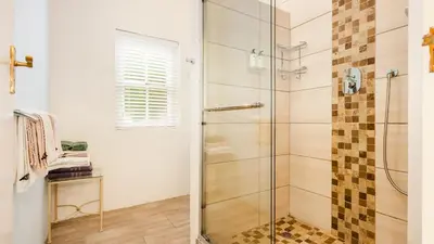 a bathroom with a shower with a glass door at Lady Loch Country House in Wellington