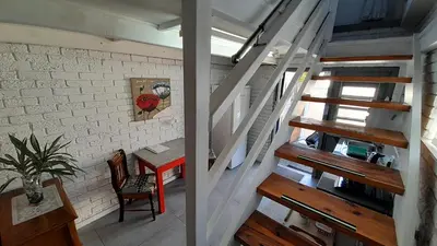a staircase leading up to a room with a table at Vergenoegd Guesthouse in Panorama