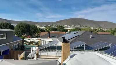 an aerial view of a house with solar panels on the roof at Vergenoegd Guesthouse in Panorama