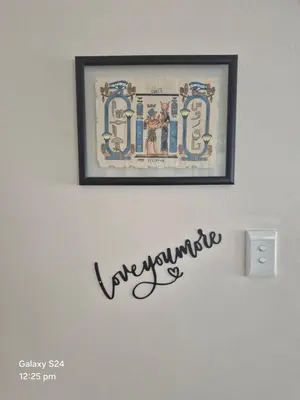 a picture hanging on a wall with a sign on it at HERMANUS , SANDBAAI holiday house in Hermanus