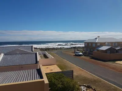 a view of the ocean from a house at HERMANUS , SANDBAAI holiday house in Hermanus