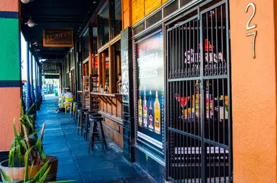an empty sidewalk in front of a building with a bar at Cape Town Micro Apartments in Cape Town