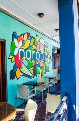 a room with a colorful wall with tables and chairs at Cape Town Micro Apartments in Cape Town