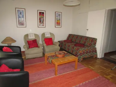 a living room with two couches and a coffee table at Pinewoods Rest in Somerset West