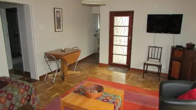 a living room with a couch and a table at Pinewoods Rest in Somerset West