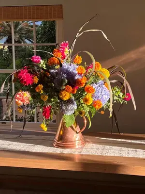 a vase filled with colorful flowers on a table at 7 Koppies in Franschhoek