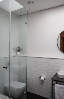 a bathroom with a toilet and a glass shower at Heritage House in Stellenbosch