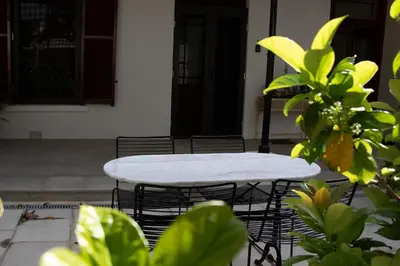 a white table and chairs in front of a house at Heritage House in Stellenbosch