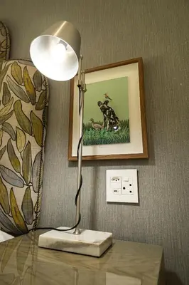 a lamp sitting on a table in a room at Cape Village Lodge in Durbanville