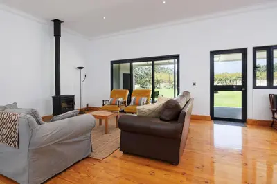 a living room with two couches and a fireplace at De Hoop Farm - Mountain View in Breerivier