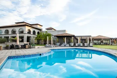 a swimming pool in front of a house at Santé Wellness Retreat & Spa in Paarl