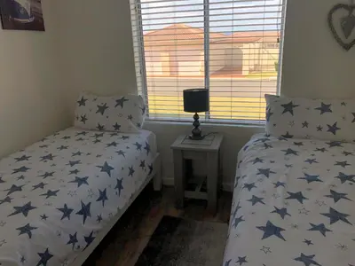a bedroom with a bed with blue stars on it at 176 hbc in Hermanus