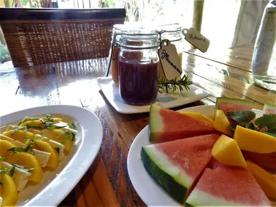a table with a plate of fruit and a jar of honey at Khashamongo B & B in Somerset West