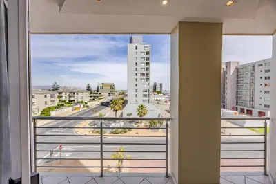a view of a city from a balcony at Luxury Ocean View Beachfront 2 bed apartment -206 The Waves, Blouberg, Cape Town in Bloubergstrand