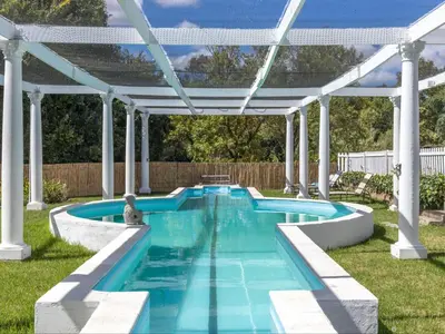 a pool with a pergola and a swimming pool at Caledon Grace Guesthouse in Caledon