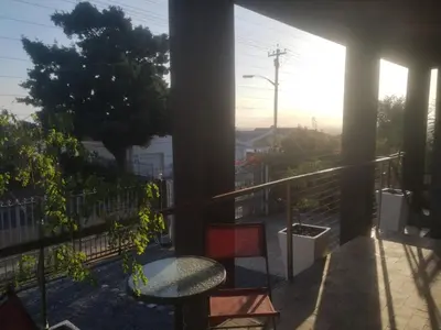 a balcony with a table and chairs on a balcony at Tranquility in Parow