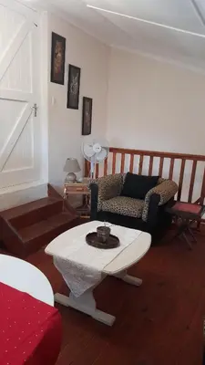 a living room with a couch and a table at Oak on Blair in Somerset West