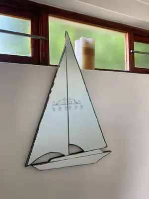 a triangle shaped light hanging on a wall next to a window at Rondawel with sea view in Kleinmond