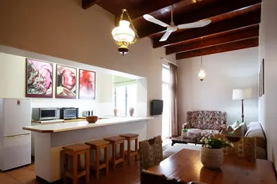 a kitchen and living room with a table and a counter at The Habit Guesthouse in Worcester