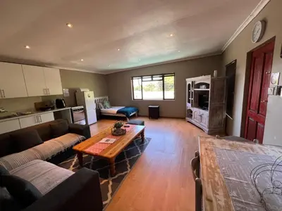 a living room with a couch and a table at 3 on Nebraska Accommodation in Bellville