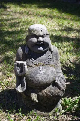 a stone statue sitting in the grass at Panorama Indlu in Cape Town