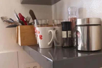 a counter with two coffee cups and other items on it at Panorama Indlu in Cape Town