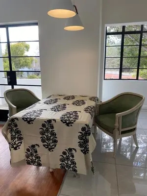 a bedroom with a bed and two chairs and windows at Becketts Bliss in Worcester