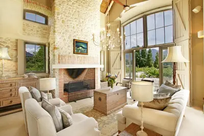 a living room with white furniture and a fireplace at Villa Simondium in Franschhoek