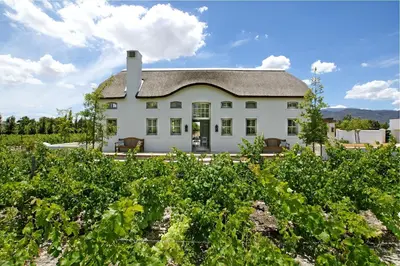 a large white house with a roof at Villa Simondium in Franschhoek