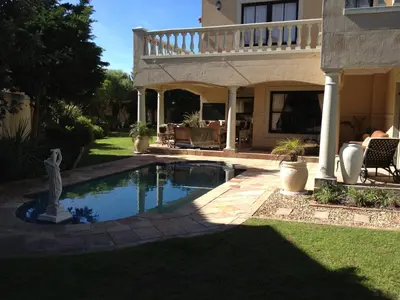 a swimming pool in the yard of a house at Roman Retreat in Cape Town