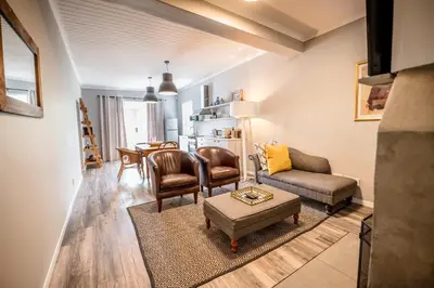 a living room with a couch and a table at The Corner House L'A-nnexe in Franschhoek