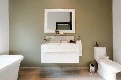 a bathroom with a white sink and a toilet at Vrede en Lust Estate in Simondium