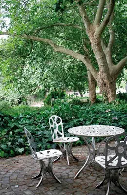 two chairs and a table and a table and chairs at Mooiplaas Wine Estate in Stellenbosch