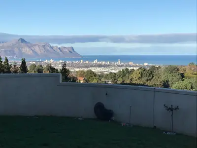 a wall with a view of the city and mountains at Wine Cottage by the Sea in Helderberg
