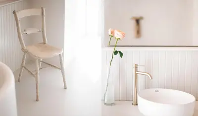 a chair and a bath tub in a bathroom at Pringle Bay Home in Pringle Bay
