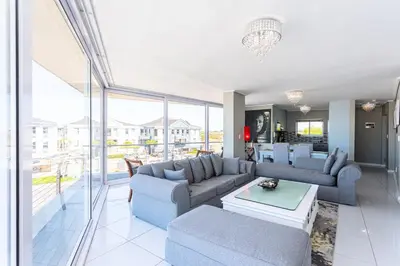 a living room with a couch and a table at Lagoon Beach 237A by CTHA in Cape Town