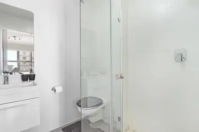 a bathroom with a toilet and a glass shower at The Paragon 317 in Cape Town