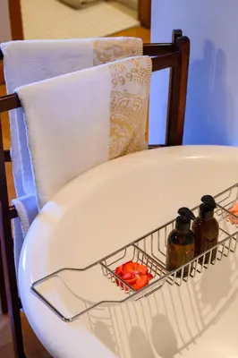 a chair with two bottles on it with a towel at Webersburg in Stellenbosch