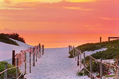 a sandy path to the beach at sunset at Dolphin Beach E5 in Bloubergstrand