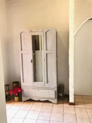 a white cabinet with a mirror in a room at The Vineyard View in Joostenberg Vlakte