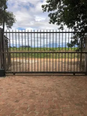 a black metal fence with a field behind it at The Vineyard View in Joostenberg Vlakte
